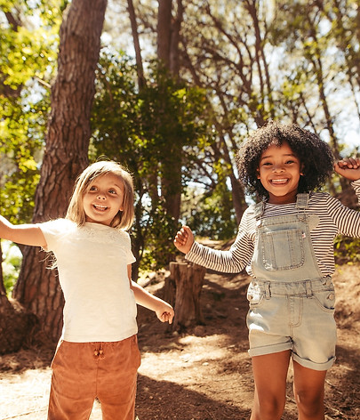 kids jumping excited forest school